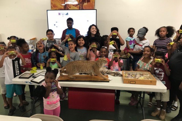 children with binoculars and taxidermy
