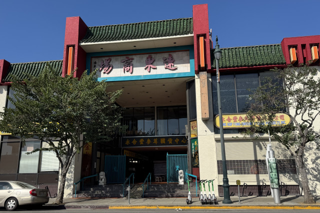 Street entrance to a multi-story shopping center built in a Chinese-style design.