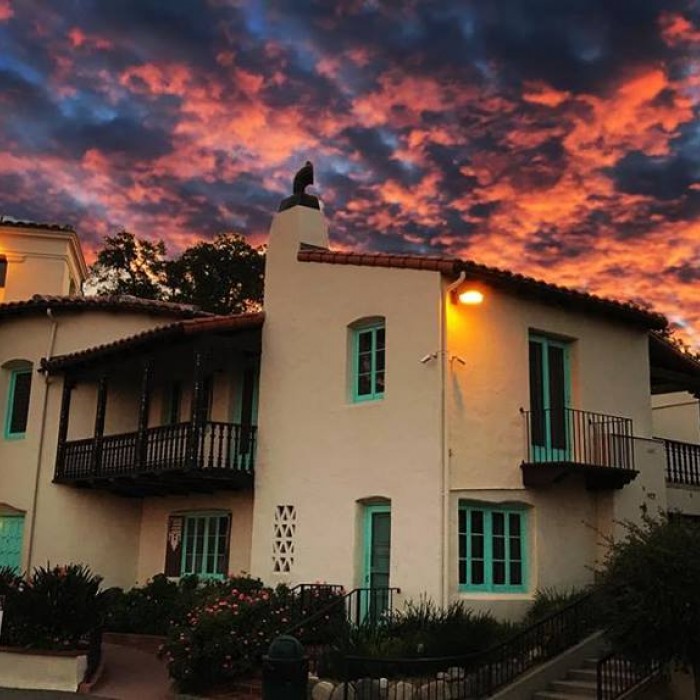 Photo of the Hart mansion with the sunsetting behind it