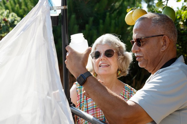 couple standing next to malaise trap