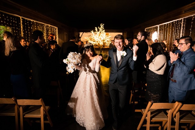 Bride and Groom walk up aisle after their wedding in the African Mammal Hall