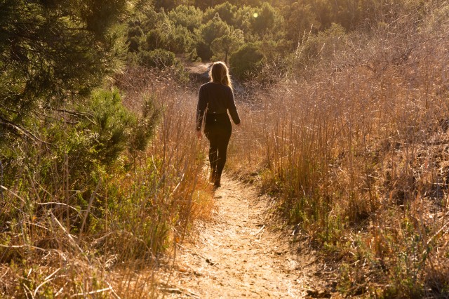 Woman walking on hiking trail in Kenneth Hahn Park