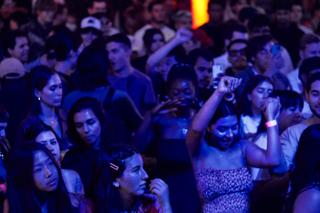 Photo of crowd dancing at an evening event 