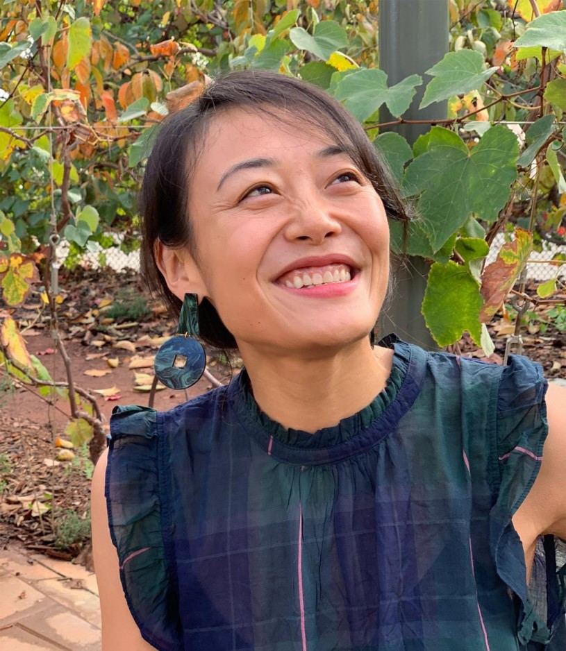Jane Li smiling, in Nature Gardens at NHM