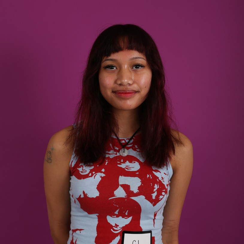 Woman with white and red shirt on purple background